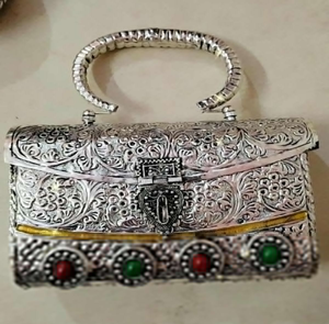 Rectangular <b>silver</b> brass hand <b>clutch</b> decorated with ornate floral scrollwork carvings, and colorful red and green at wholesale. - Product Image 1