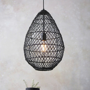 Black, teardrop-shaped lampshade woven from natural rattan, a decorative pendant lamp for home interiors, - Product Image 1