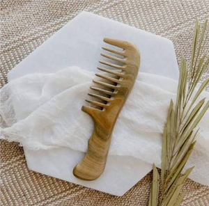 Polished wooden <b>comb</b> designed with a curved ergonomic handle and <b>wide</b> teeth for smooth detangling, available at wholesale prices - Product Image 1