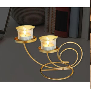 Elegant minimalist gold iron scrollwork dual candle stand holding two clear glass tealight cups. Available at wholesale price. - Product Image 1