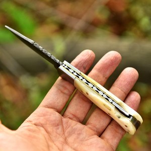 UA Supplies OEM Industrial Grade Damascus Steel Foldable Pocket <b>Knife</b> <b>Bone</b> <b>Handle</b> Clip Point Blade 0.5mm Thick Thumb Knob - Product Image 5