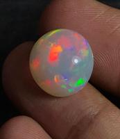 Opale d'Éthiopie naturelle multicolore et chatoyante, cabochon rond.