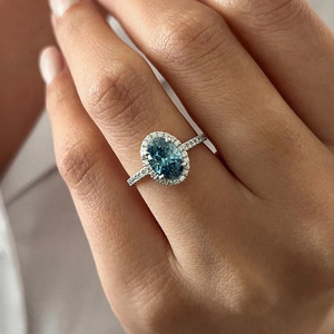 Bague de fiançailles de luxe en or blanc 14 carats avec moissanite bleue taille ovale, halo et bande pavée de diamants VVS cultivés en laboratoire pour femme - Product Image 1