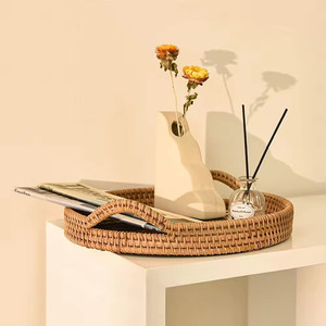 Round serving tray, a harmonious combination of rattan and natural bamboo. Features a handle. - Product Image 1