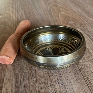 Brass singing bowl with polished golden rim and engraved Dharma wheel symbol on the exterior, available at wholesale prices. - Product Image 4