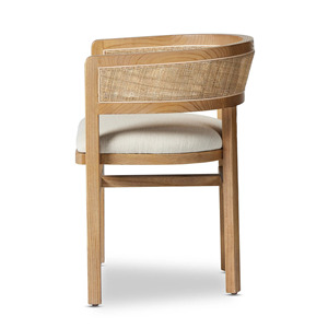 Esta es la silla de comedor Four Hands Cordoba, que tiene una estructura de madera de teca maciza en un color natural con un respaldo tejido de ratán. - Product Image 3