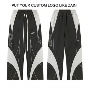 Pantalon de survêtement coupe-vent en nylon premium 120 GSM, noir et blanc avec empiècements contrastants, logo personnalisé par transfert thermique, vêtement de sport stylé - Product Image 1