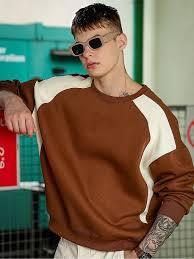 Classic crewneck pullover featuring a unique multi-tone construction with deep brown, cream, and black accents. - Product Image 4