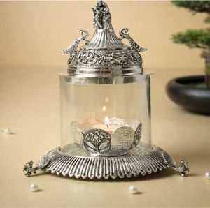 <b>Silver</b> Plated Carved Peacock Dome Glass Akhand Jyoti Diya Lantern Stand Holder, available at wholesale prices. - Product Image 1