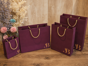 Premium <b>Paper</b> Gift Shopping Bags with Gold Rope Handles Wholesale Custom Packaging Solutions - Product Image 1