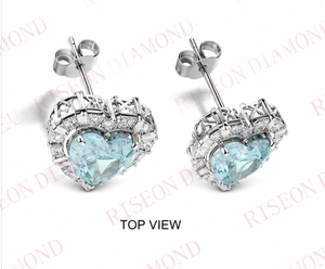 Elegant heart shaped blue diamond <b>stud</b> earrings with halo of round and baguette white diamonds in luxurious 18K white gold desig - Product Image 6