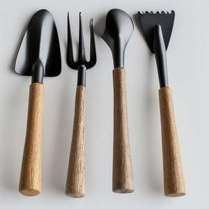 Assortiment d'outils de jardin modernes noirs et en bois avec truelle, fourche et désherbeur pour les travaux du sol - Product Image 1