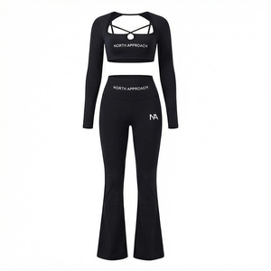 Ensemble de yoga 2 pièces North Approach : haut court noir uni à bretelles croisées et pantalon évasé taille haute - Product Image 1