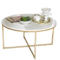 Petite table basse ronde en marbre blanc naturel avec des veines grises et une base en acier géométrique en croix