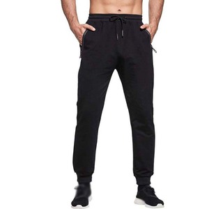 Pantalon de jogging noir pour homme avec cordon de serrage, taille élastique, poches zippées et bas de pantalon à revers – Style sportif - Product Image 1
