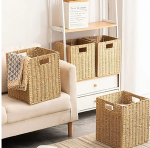 Small <b>rectangular</b> woven <b>basket</b> shown with its lid propped open on a table alongside festive ritual items available at wholesale. - Product Image 5