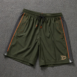 Shorts de pickleball personnalisés vert olive, anti-humidité, en poly-spandex, avec poches zippées et détails orange - Product Image 1