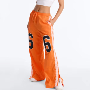 Pantalon de survêtement graphique orange personnalisé pour femme, coupe large avec lacets latéraux, décontracté, avec cordon de serrage, fabrication OEM, pantalon pour homme - Product Image 1