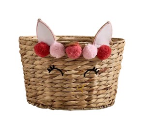 Cesta de Almacenamiento de Jacinto de Agua con Diseño de Cara de Conejo y Pompones, Organizador de Juguetes de Animales Tejido con Parte Superior Abierta, Decoración para Guardería - Product Image 1