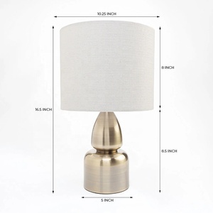 Aurora Sculpted Metal Table <b>Lamp</b> with Linen Drum Shade Antique Brass Finish Soft Ambient Lighting for Elegant Interiors - Product Image 6