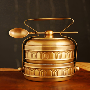 Arch embossed brass tiffin <b>box</b>, 2 tier gold lunch <b>box</b> with spoon, traditional patterned food carrier, at wholesale prices. - Product Image 1