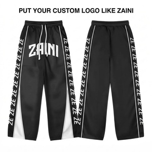 Pantalon de survêtement coupe-vent léger 100 % coton réversible avec empiècements contrastants noir/blanc, fermeture à cordon de serrage et motif imprimé pour homme - Product Image 1
