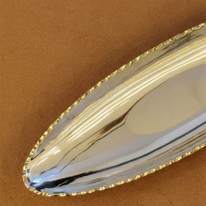 Ce plateau élégant finition argentée présente un design ovale pointu et une bordure dorée détaillée, offrant un luxe pour le service et la décoration. - Product Image 5