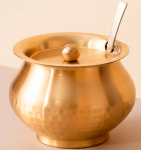 Timeless brass ghee <b>pot</b> accented by an intricate floral border engraving and a matching spoon. Available at wholesale price. - Product Image 4
