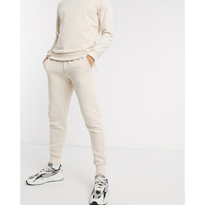 Pantalon de survêtement unisexe en coton crème avec poches latérales, taille élastique, coupe décontractée, idéal pour l'automne - Product Image 1