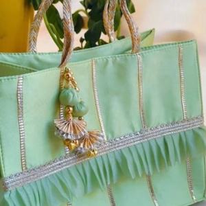 Elegant Mint Green Handcrafted Potli Tote Bag with Ruffled Detailing Golden Tassel Charm & Braided Handles for Festive Gifting - Product Image 1