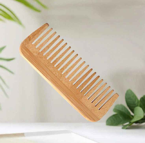 Polished wooden <b>comb</b> designed with a curved ergonomic handle and <b>wide</b> teeth for smooth detangling, available at wholesale prices - Product Image 4