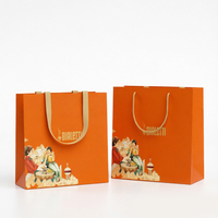 Emballage cadeau de luxe en papier blanc et orange avec accents dorés coordonnés pour le branding de marques haut de gamme de thé et de café, idéal pour les supermarchés