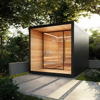 Sauna en bois en forme de cube, extérieur noir élégant, intérieur en bois naturel, murs vitrés panoramiques, écologique, sûr, traditionnel