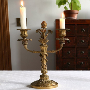 Gold vintage brass two <b>light</b> floral candelabra featuring a central bud stem accent, available at wholesale prices. - Product Image 1