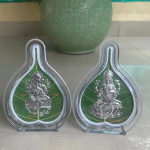 Handcrafted Pure 999 <b>Silver</b> Lord Ganesha and Goddess Lakshmi Idols on Sacred Peepal Leaf Base in Protective Acrylic Frame - Product Image 1