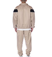Ensemble de survêtement beige pour homme, 2 pièces, avec veste coupe-vent sportive à motif chevron noir et pantalon à fermeture éclair intégrale
