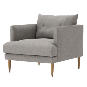 The Kalmar single-arm chair features tapered wooden legs, a button-accented back cushion, and a modern design - Product Image 1