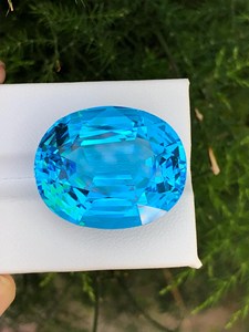 พลอยบลูโทแพซธรรมชาติทรงรี รับรองโดย IGI  หินหลวมสีอ่อนจาก Zubeda Gems Rajasthan สำหรับทำเครื่องประดับ ขายส่ง - Product Image 1