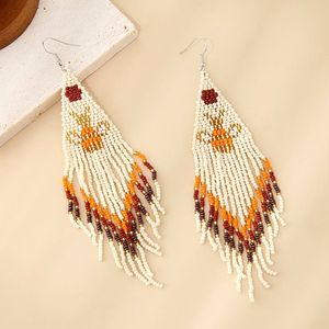 Pendientes de cuentas de arroz pequeñas de estilo étnico europeo y americano, con borlas largas de animales tejidas a mano. - Product Image 2