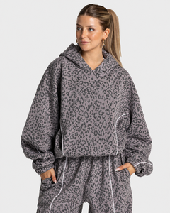 Vente en gros de sweat-shirts à capuche pour femmes en polaire premium doux, à manches longues, avec imprimé léopard graphite et détails contrastés, pour l'hiver - Product Image 1