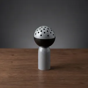Brûleur à Bakhoor moderne gris et noir en métal, avec une base cylindrique élégante et un couvercle sphérique perforé, pour parfumer la maison - Product Image 1