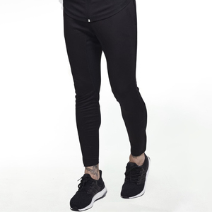 Jogging décontracté noir uni pour homme avec logo, taille élastique, en maille respirante, polyester et coton, poches latérales, idéal pour l'automne - Product Image 1