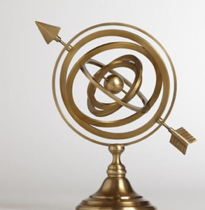 Minimalist brass armillary sphere featuring central globe and arrow, available at wholesale prices. - Product Image 1
