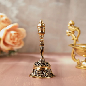 Antique finish brass hand bell featuring ornate floral carvings and layered finial, available at wholesale prices. - Product Image 1