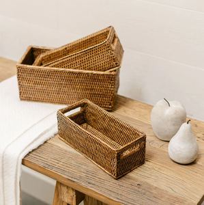 Dark-stained <b>rectangular</b> rattan <b>storage</b> <b>basket</b> featuring a fine weave and dark leather loop handles on the ends, at wholesale. - Product Image 4