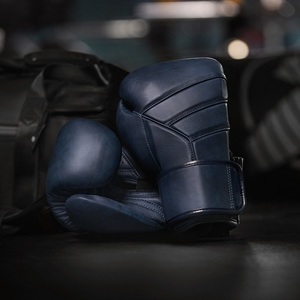 ขายส่งถุงมือชกมวยปี 2026 แบบกำหนดโลโก้ได้ ทนทาน คุณภาพสูง สำหรับออกกำลังกายและฝึกซ้อม ขนาด XL สำหรับผู้ใหญ่ ป้องกันมือ ขนาด 6oz 10oz 14oz ผลิตตามสั่ง - Product Image 1