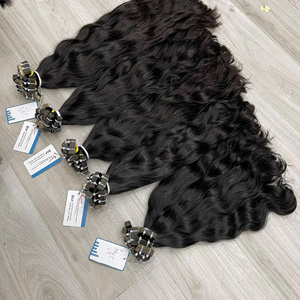 Precio al por mayor Natural Black Raw Wavy Bundle 100% Cinta vietnamita en extensiones de cabello Sin enredos Sin desprendimiento Super sedoso En stock - Product Image 1