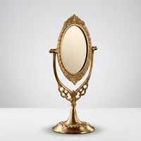 Miroir de table ovale vintage doré avec cadre sculpté orné et support rotatif pour coiffeuse et décoration de chambre