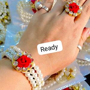 Elegant handcrafted pearl <b>bracelet</b> and matching ring set featuring a vibrant <b>red</b> rose centerpiece sparkling kundan-style stones - Product Image 1