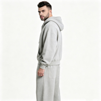 Ensemble de survêtement décontracté haut de gamme gris clair moderne, respirant, avec sweat à capuche zippé et pantalon large à cordon de serrage, deux pièces